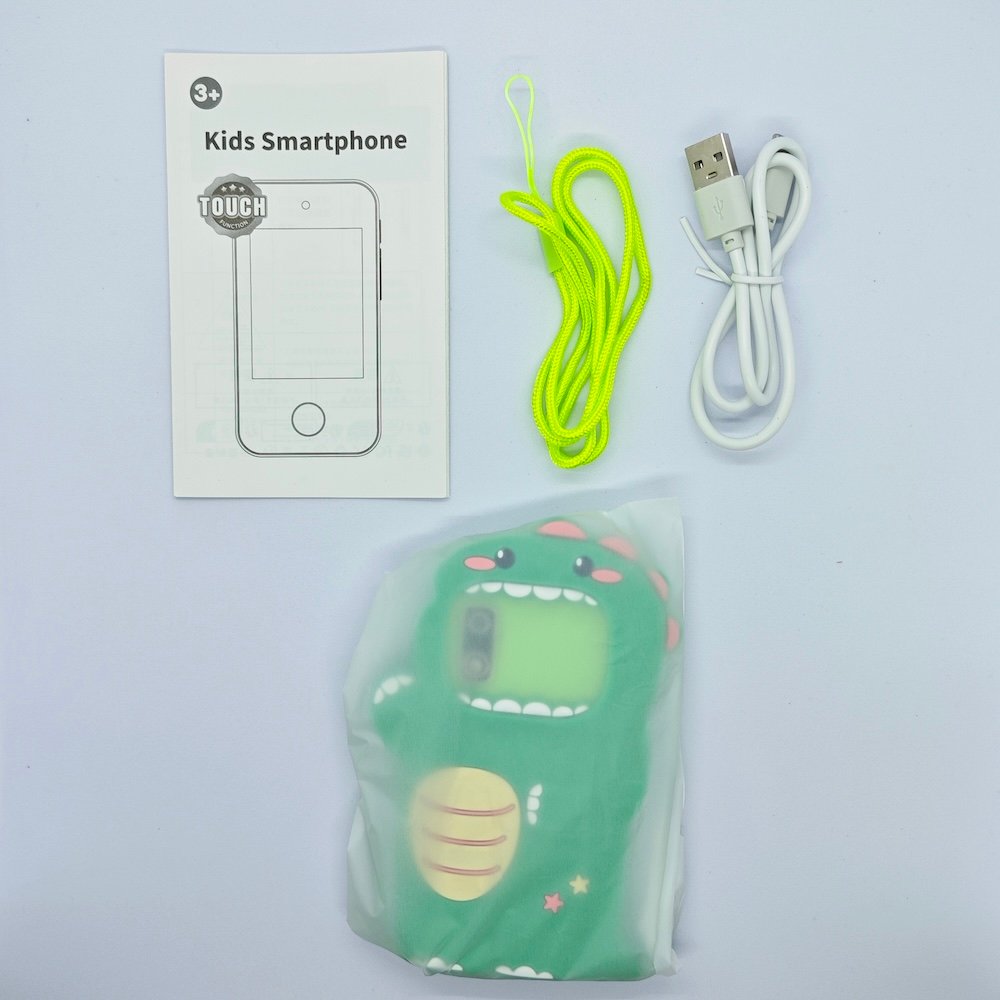 Full kit of A10 monster dinosaur smartphone-shaped camera in green with lanyard and cable for toy distributors.