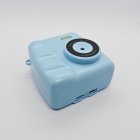 Close-up of Q8 instant print camera in blue for kids showing front HD lens, memory card slot and charging port with factory price.