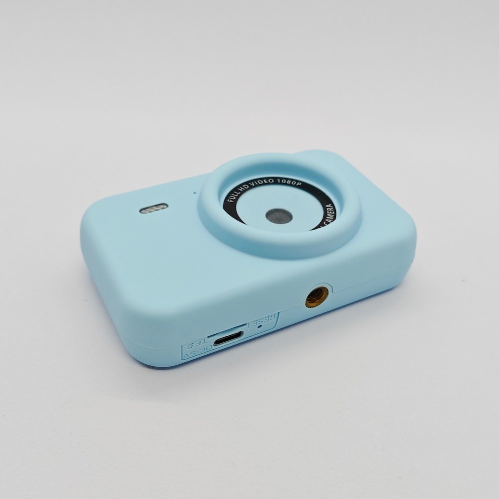 CE/RoHS certified Y1 kids camera in blue featuring Type-C charging port, TF card slot and standard tripod mounting hole.