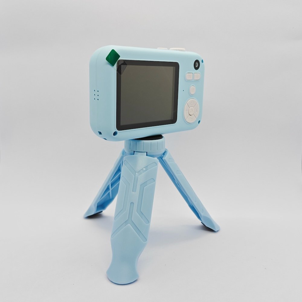Y1 kids digital camera mounted on a matching blue tripod with a clear rear display for B2B wholesale.