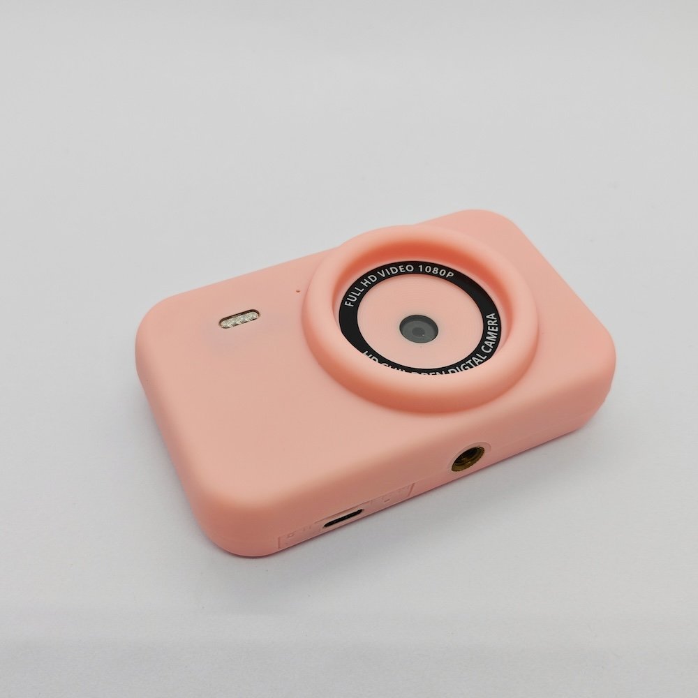 CE/RoHS certified Y1 kids camera in pink featuring Type-C charging port, TF card slot and standard tripod mounting hole.