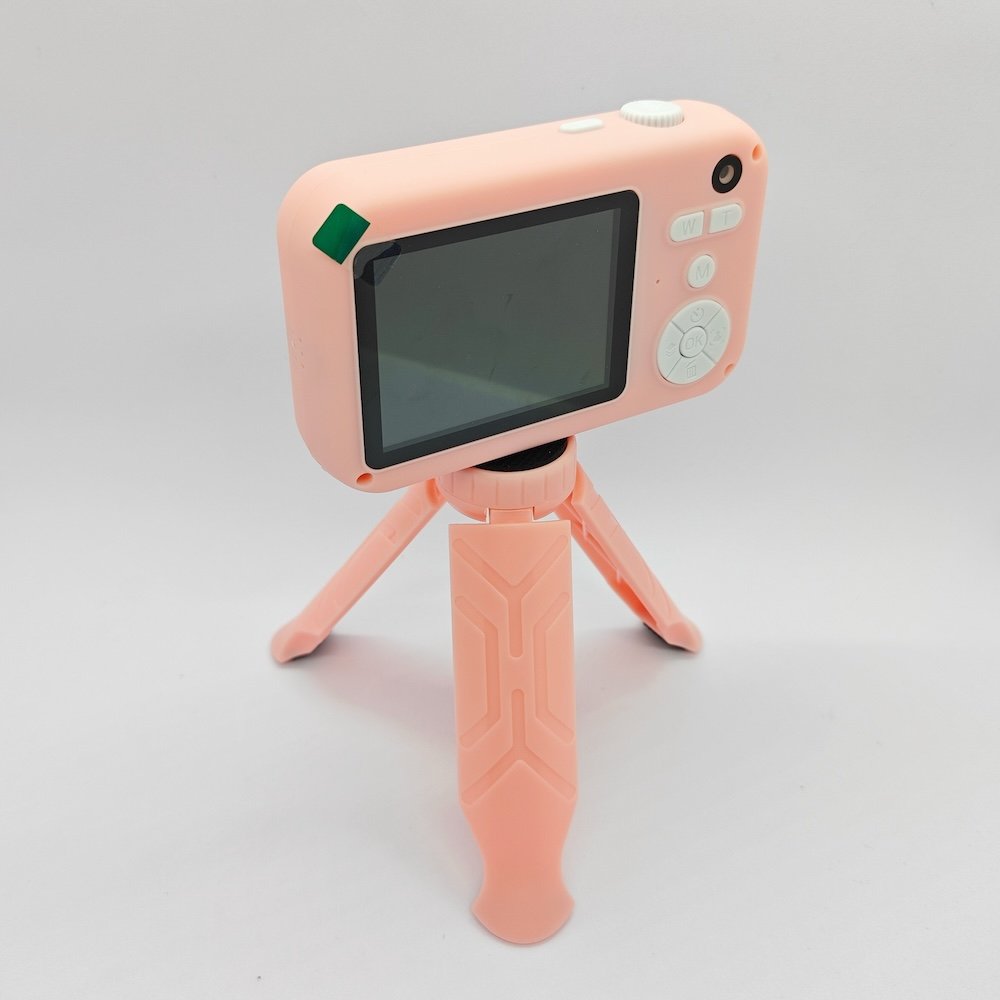 Y1 kids digital camera mounted on a matching pink tripod with a clear rear display for B2B wholesale.