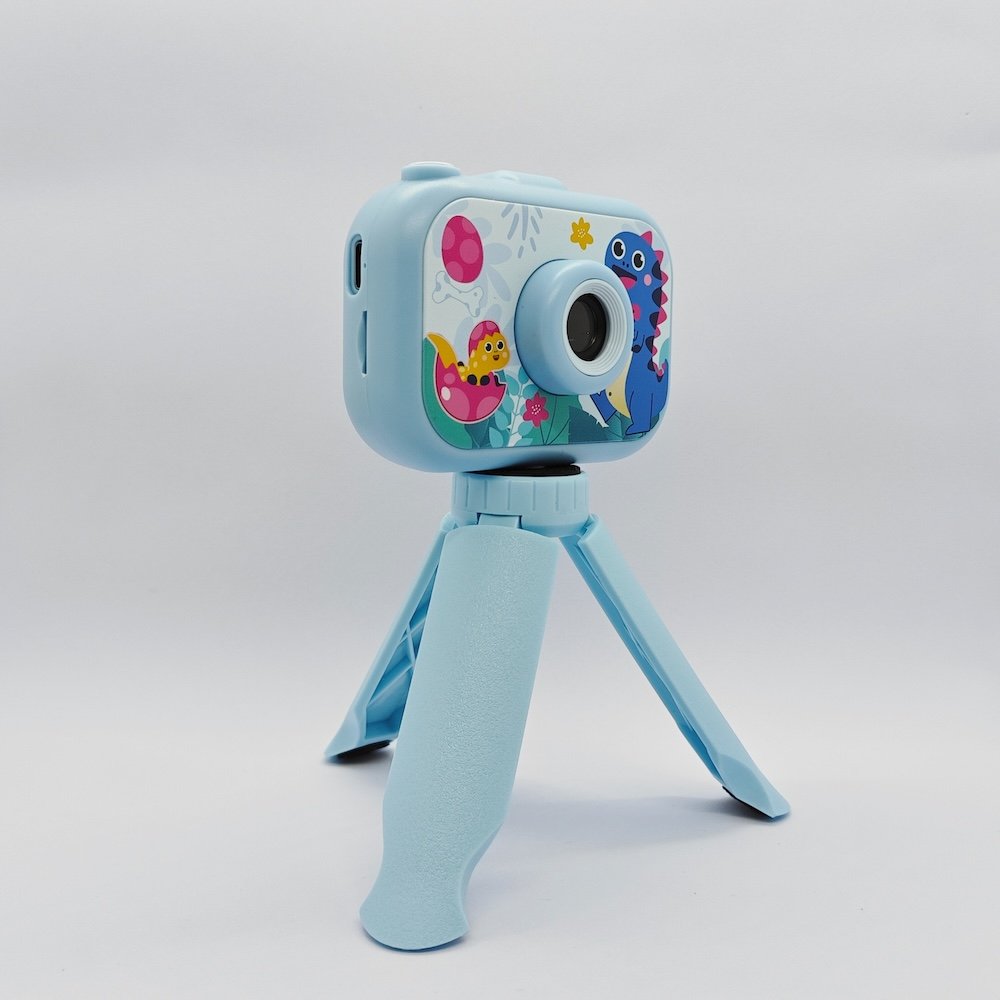 Y6 dual lens children digital camera with cute dinosaur patterns and matching blue tripod for retailers.