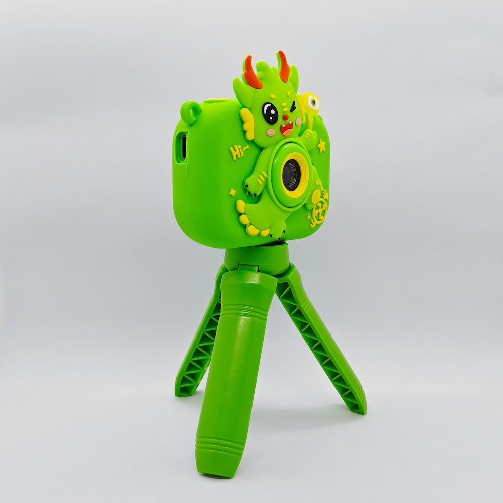 Y6 shockproof silicone kids camera with 3D green dragon scales, features USB-C port and memory card slot for retail.