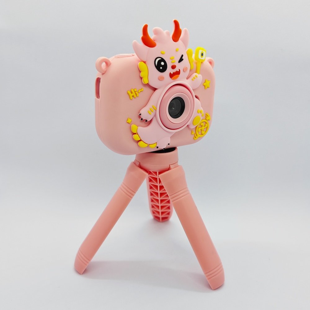 Y6 shockproof silicone kids camera with 3D pink dragon scales, features USB-C port and memory card slot for retail.