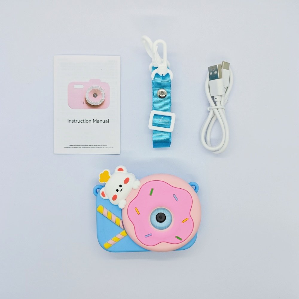 Wholesale full Y8 kids camera kit including blue silicone case with pink donut on it, USB cable, lanyard and manual for toy distributors.