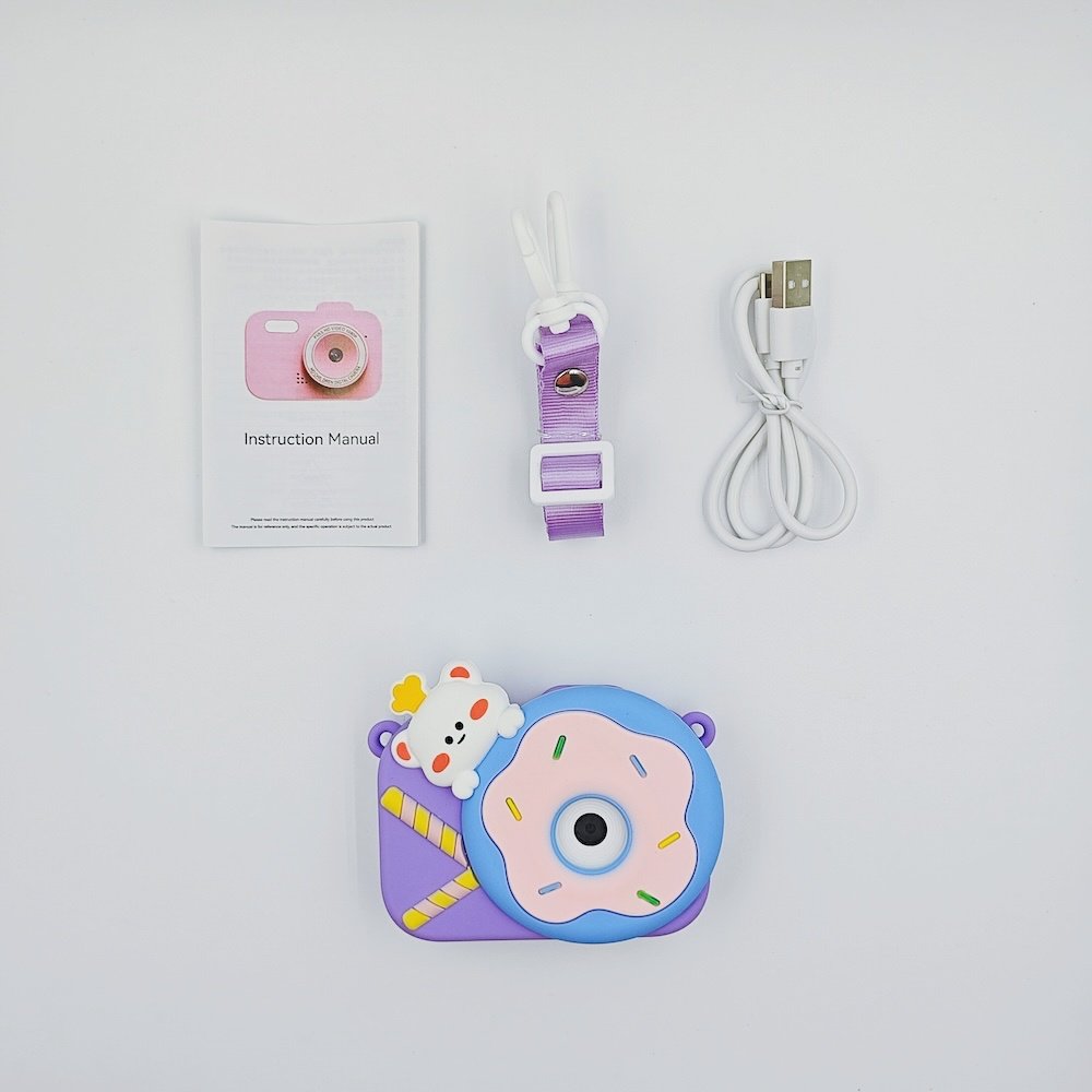 Wholesale full Y8 kids camera kit including purple silicone case with blue donut on it, USB cable, lanyard and manual for toy distributors.