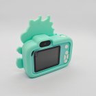 Rear view of CE certified Y8 kids camera with light green dragon silicone cover, integrated 2.0-inch screen and white buttons.