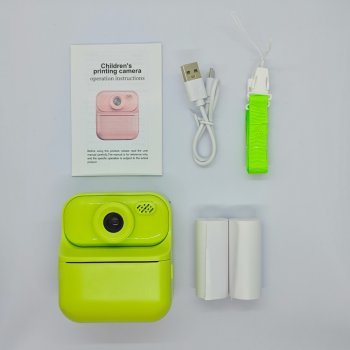 Complete kit of green Y900 kids print camera, includes 2 rolls of thermal paper, lanyard and cable. RoHS/FCC certified toys for distributors.